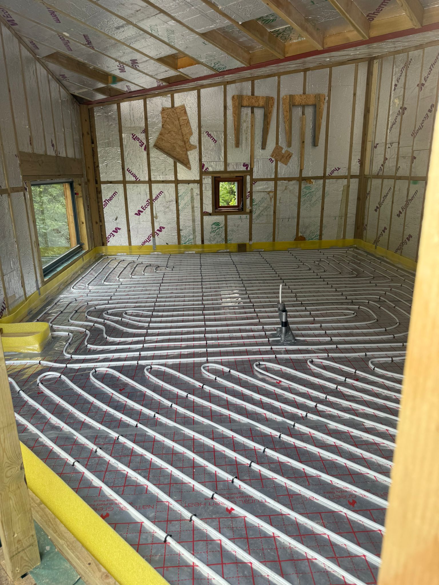 Full screed underfloor heating pipework laid for an air source heat pump system
