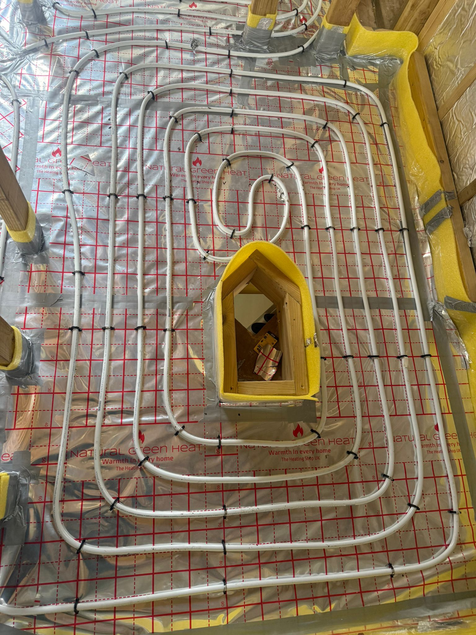 Full screed underfloor heating pipework laid for an air source heat pump system