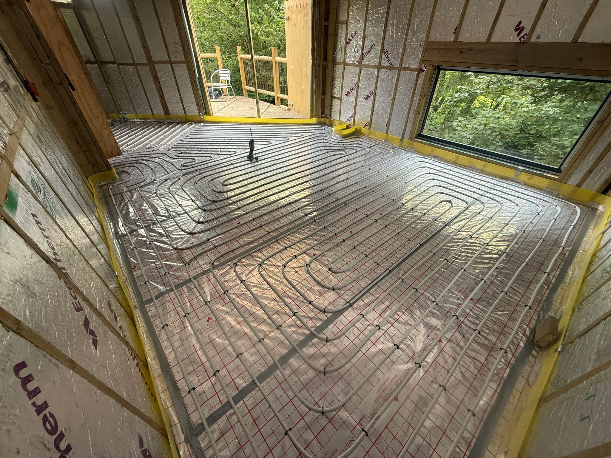 Full screed underfloor heating pipework laid for an air source heat pump system